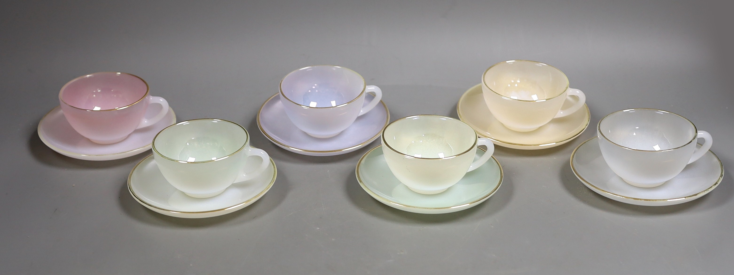 A set of six opalescent glass cups and saucers